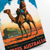 A vintage travel poster featuring a stylized landscape of Australia in black and blue tones - as a rolled, unframed print