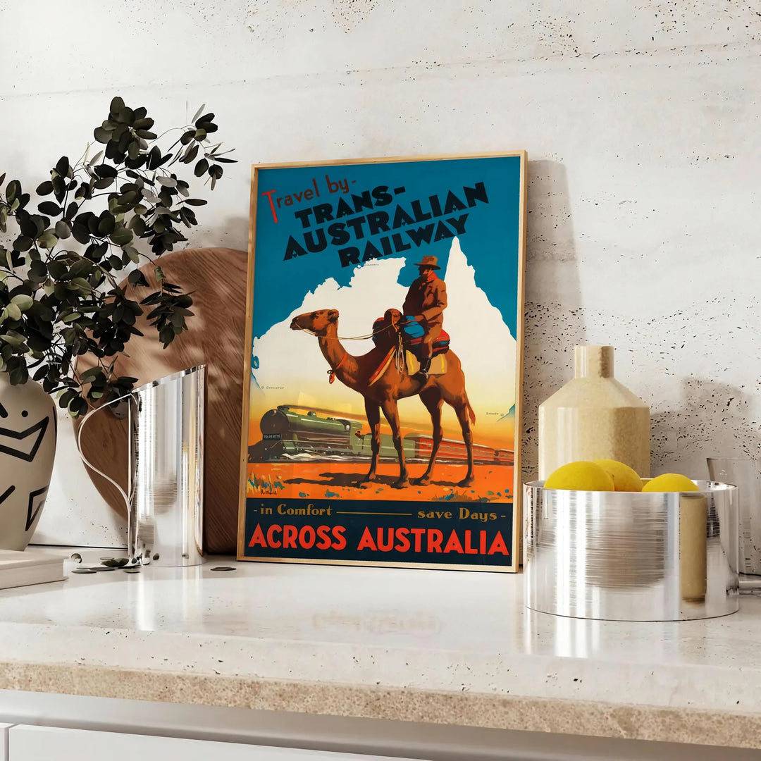 Retro travel poster featuring the Trans Australian Railway with green and blue tones - styled on a counter with eucalyptus and a bowl of lemons