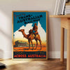 Retro travel poster featuring the Trans Australian Railway with green and blue tones - beside a round wooden side table with books