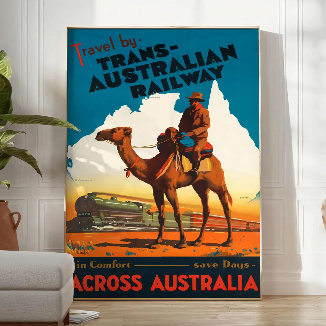 Retro travel poster featuring the Trans Australian Railway with green and blue tones - in a bright minimalist room with a plant and an armchair