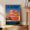 Vintage travel poster featuring the Trans Australian Railway in green and black hues - beside a round wooden side table with books