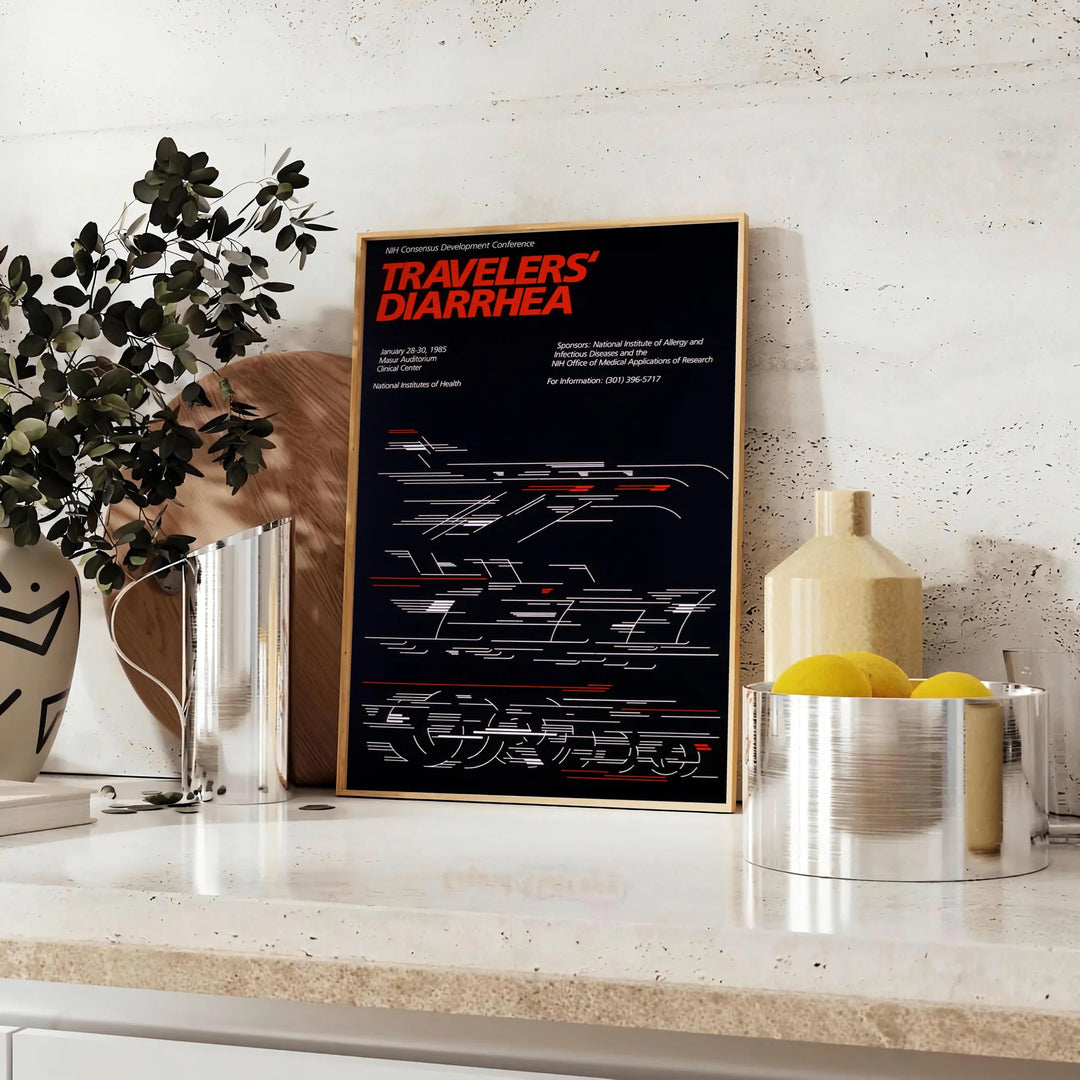 A humorous travel poster featuring a cartoonish traveler with a distressed expression, predominantly black and red colors. - styled on a counter with eucalyptus and a bowl of lemons