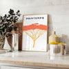 A stylized tree with various animal silhouettes in black and orange hues - styled on a counter with eucalyptus and a bowl of lemons
