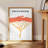 A stylized tree with various animal silhouettes in black and orange hues - beside a round wooden side table with books