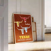 American Airlines travel poster featuring Texas with bold orange and yellow colors - leaning on a herringbone floor against a white panelled wall