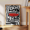 Abstract modern art with black and gray tones, evoking a sense of space - beside a round wooden side table with books