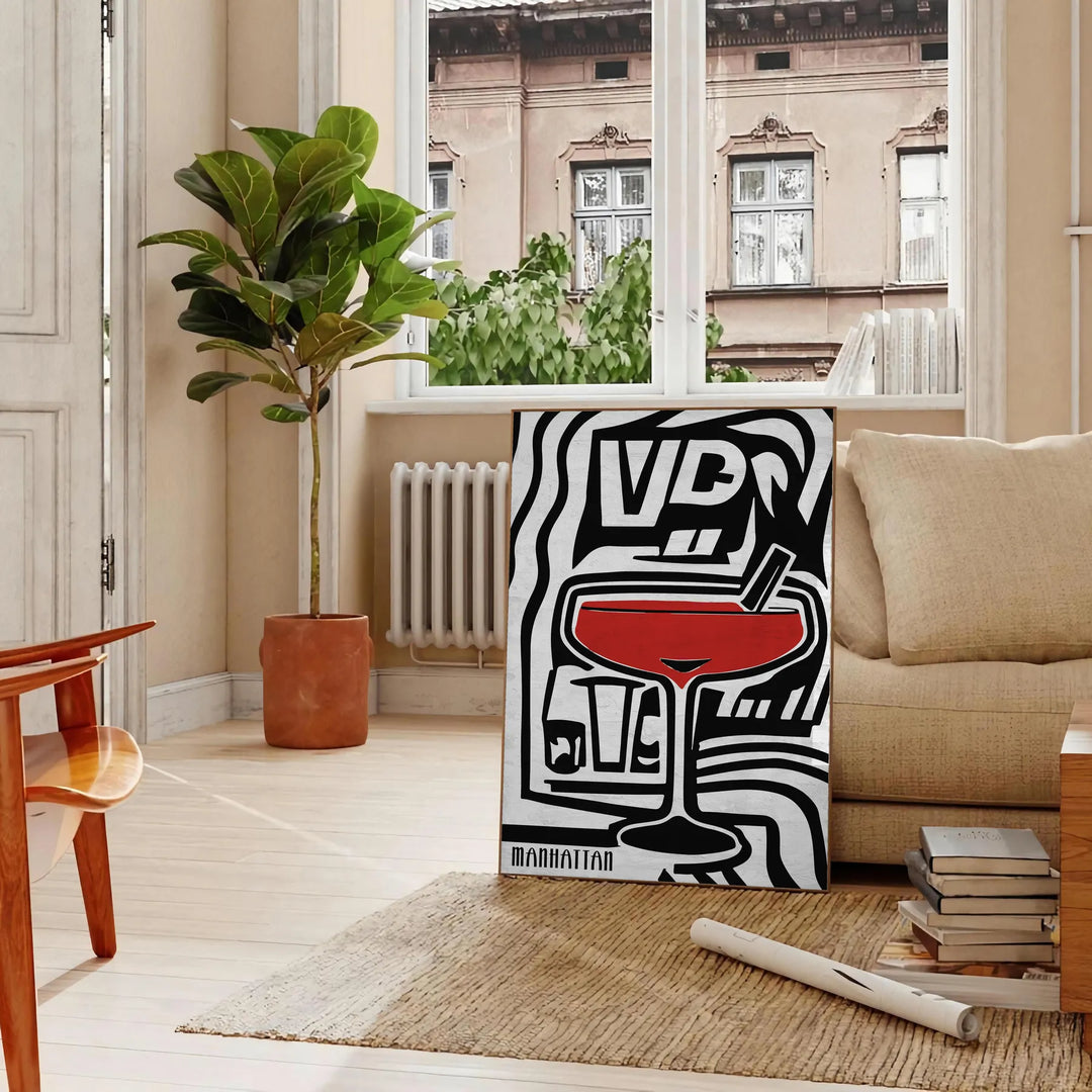 Abstract modern art with black and gray tones, evoking a sense of space - in a Parisian living room with a sofa and a fig plant