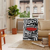 Abstract modern art with black and gray tones, evoking a sense of space - in a Parisian living room with a sofa and a fig plant