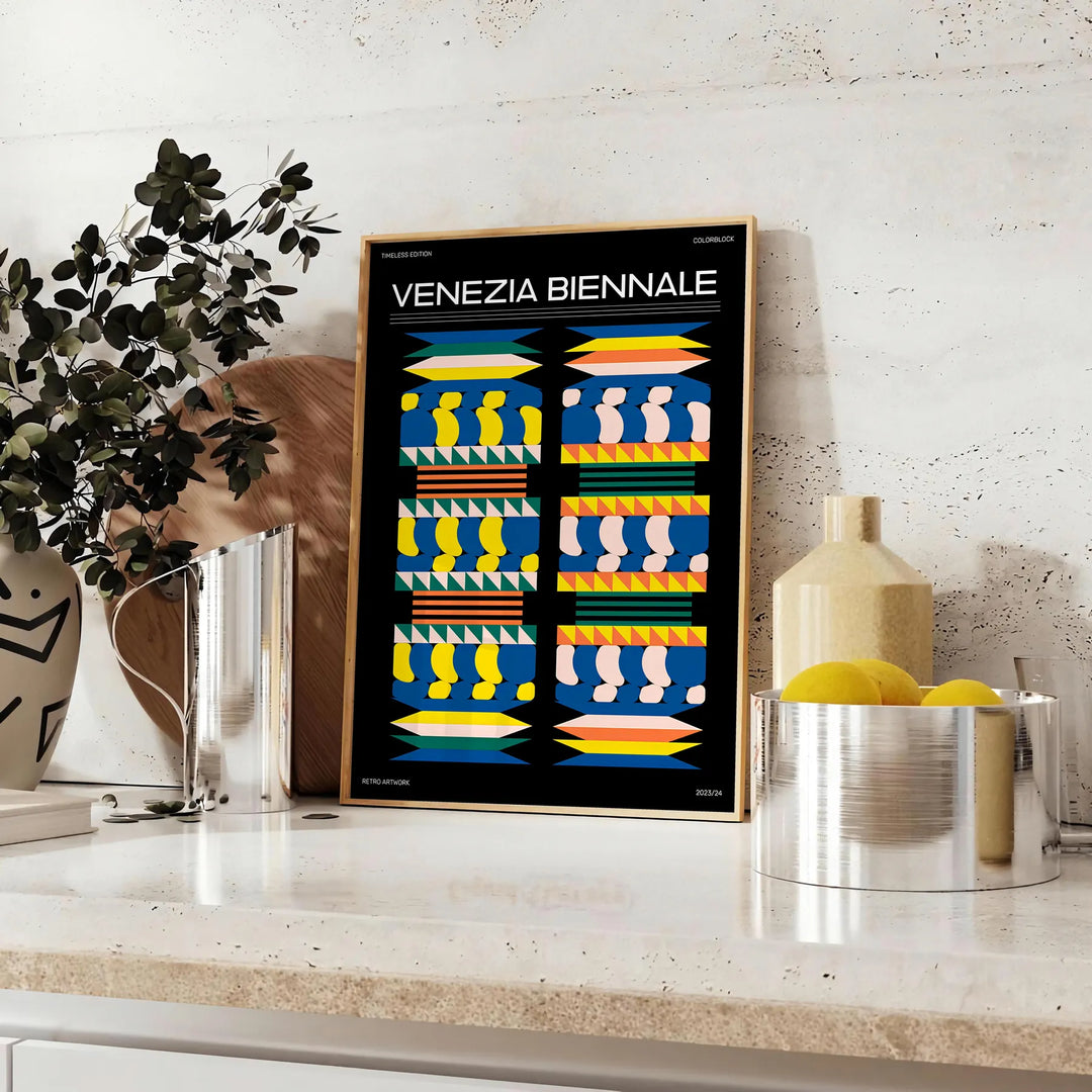 Póster de arte moderno con colores negros y amarillos audaces inspirado en la Bienal de Venecia - sobre una encimera con eucalipto y un cuenco de limones