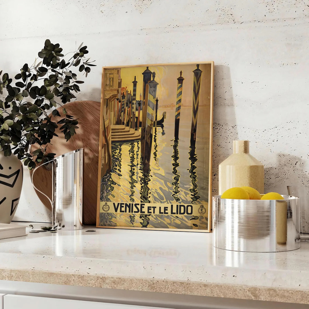 Stylized illustration of Venice canals with gondolas, in gray and black tones - styled on a counter with eucalyptus and a bowl of lemons