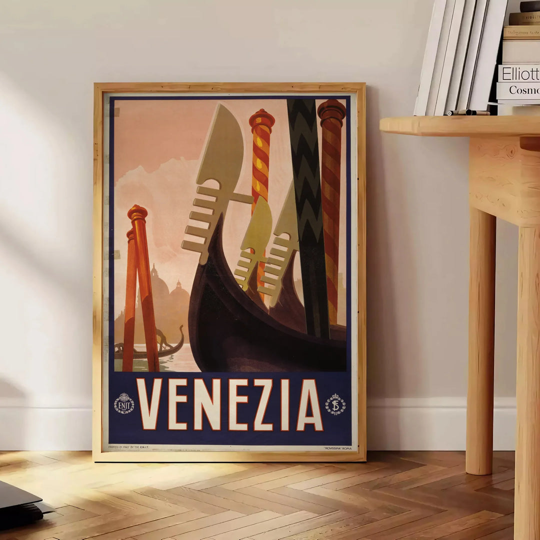 A vintage-style poster featuring iconic Venice canals and gondolas in green and black tones - beside a round wooden side table with books