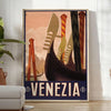 A vintage-style poster featuring iconic Venice canals and gondolas in green and black tones - in a bright minimalist room with a plant and an armchair