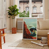 Abstract mountain landscape with black and orange hues - in a Parisian living room with a sofa and a fig plant