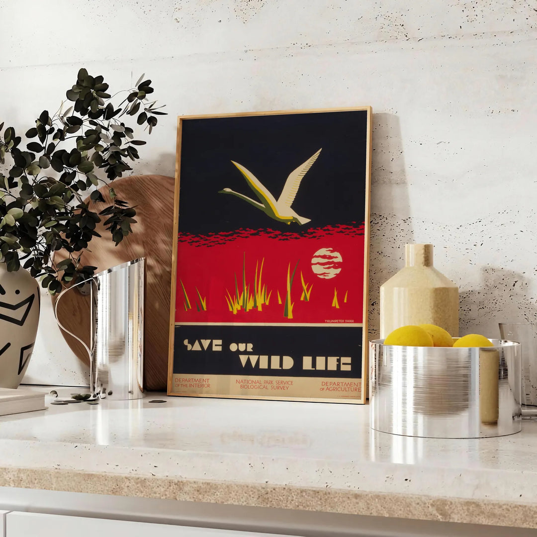 Vintage travel poster featuring bold black and orange colors - styled on a counter with eucalyptus and a bowl of lemons