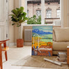 vintage poster of Queenstown featuring lush green landscapes and serene blue skies - in a Parisian living room with a sofa and a fig plant