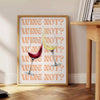 A playful kitchen poster featuring the phrase 'Wine Not' in bold letters, with yellow and purple colors. - beside a round wooden side table with books