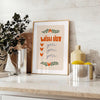 A minimalist poster featuring a wish list in gray and green tones - styled on a counter with eucalyptus and a bowl of lemons