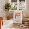 A minimalist poster featuring a wish list in gray and green tones - in a Parisian living room with a sofa and a fig plant