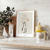 Silhouette of a woman in bohemian style against gray and black background - styled on a counter with eucalyptus and a bowl of lemons