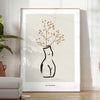 Silhouette of a woman in bohemian style against gray and black background - in a bright minimalist room with a plant and an armchair