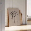 A bohemian woman with flowing hair surrounded by abstract shapes and earthy tones - leaning on a herringbone floor against a white panelled wall