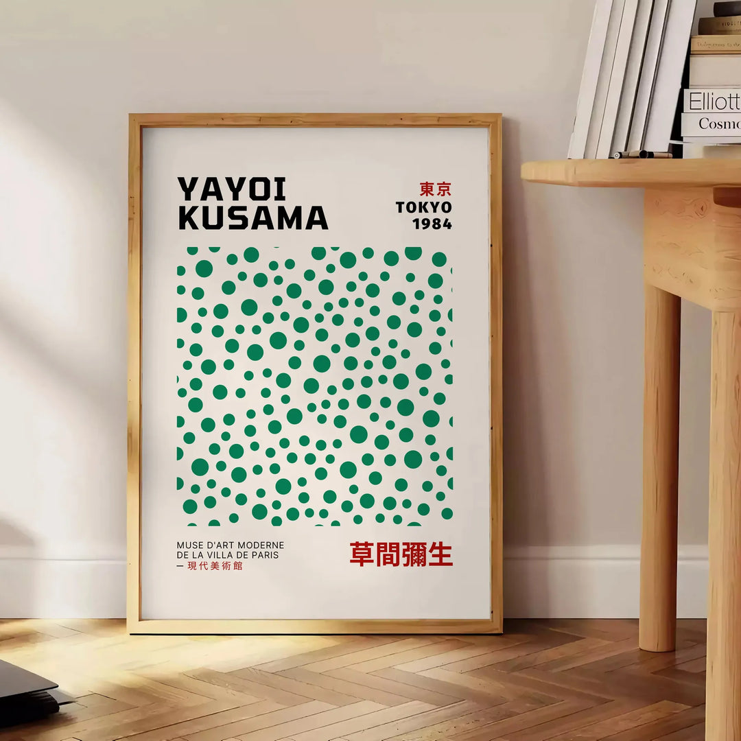 Abstract polka dot patterns in gray and blue by Yayoi Kusama - beside a round wooden side table with books