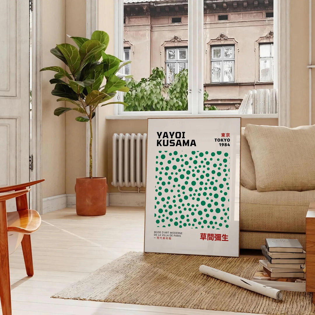 Abstract polka dot patterns in gray and blue by Yayoi Kusama - in a Parisian living room with a sofa and a fig plant