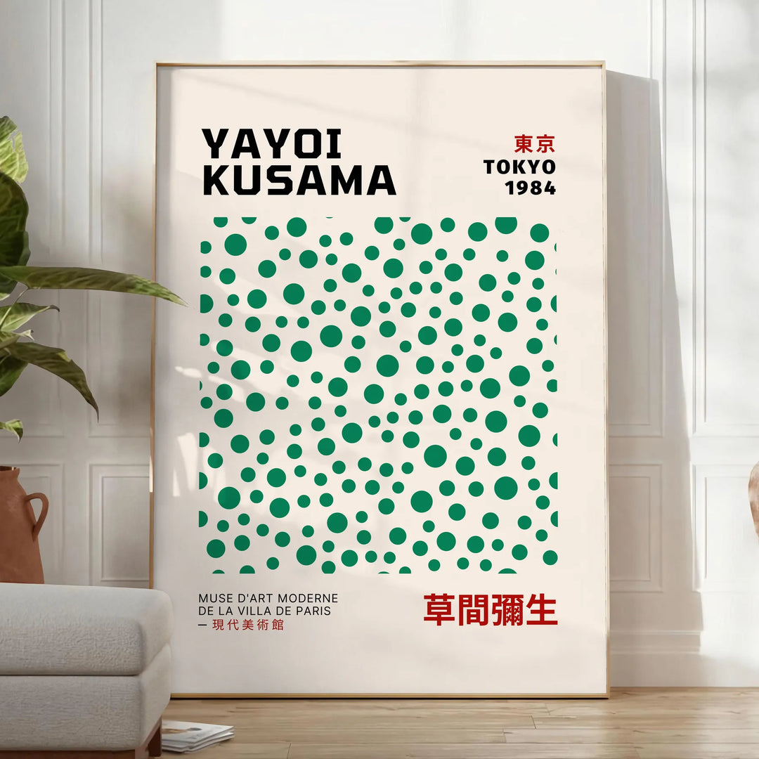 Abstract polka dot patterns in gray and blue by Yayoi Kusama - in a bright minimalist room with a plant and an armchair