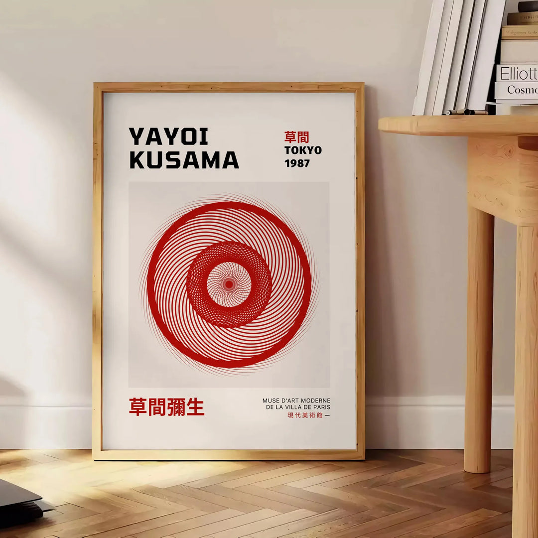 Abstract pattern of black dots on an orange background by Yayoi Kusama - beside a round wooden side table with books