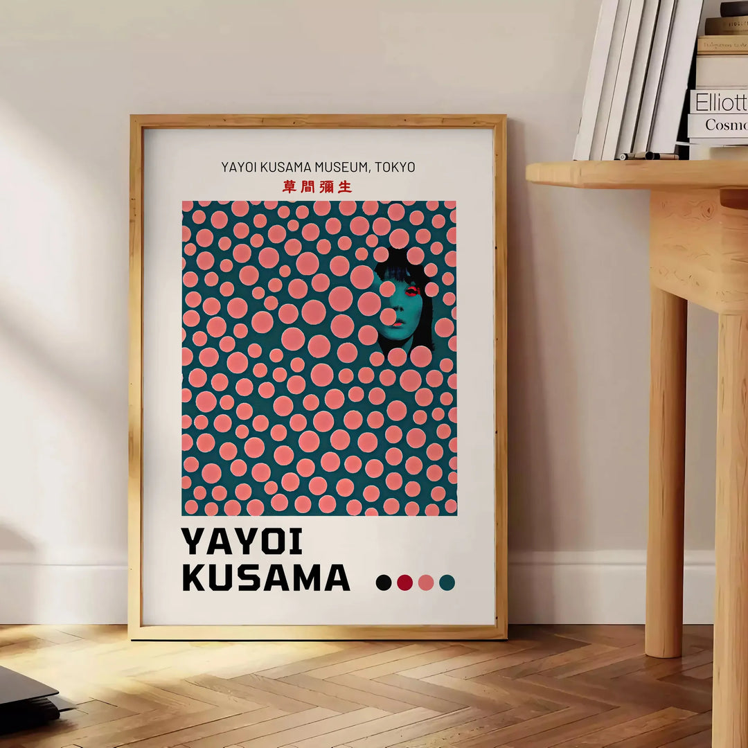 Abstract polka dot pattern in green and orange by Yayoi Kusama - beside a round wooden side table with books