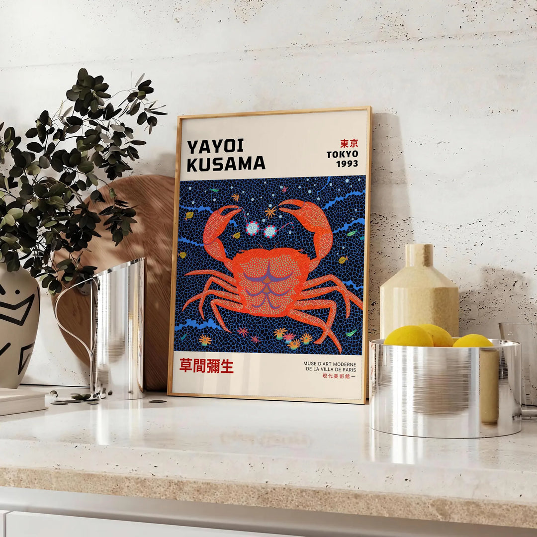 Abstract polka dot patterns in orange and blue by Yayoi Kusama - styled on a counter with eucalyptus and a bowl of lemons