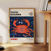 Abstract polka dot patterns in orange and blue by Yayoi Kusama - beside a round wooden side table with books
