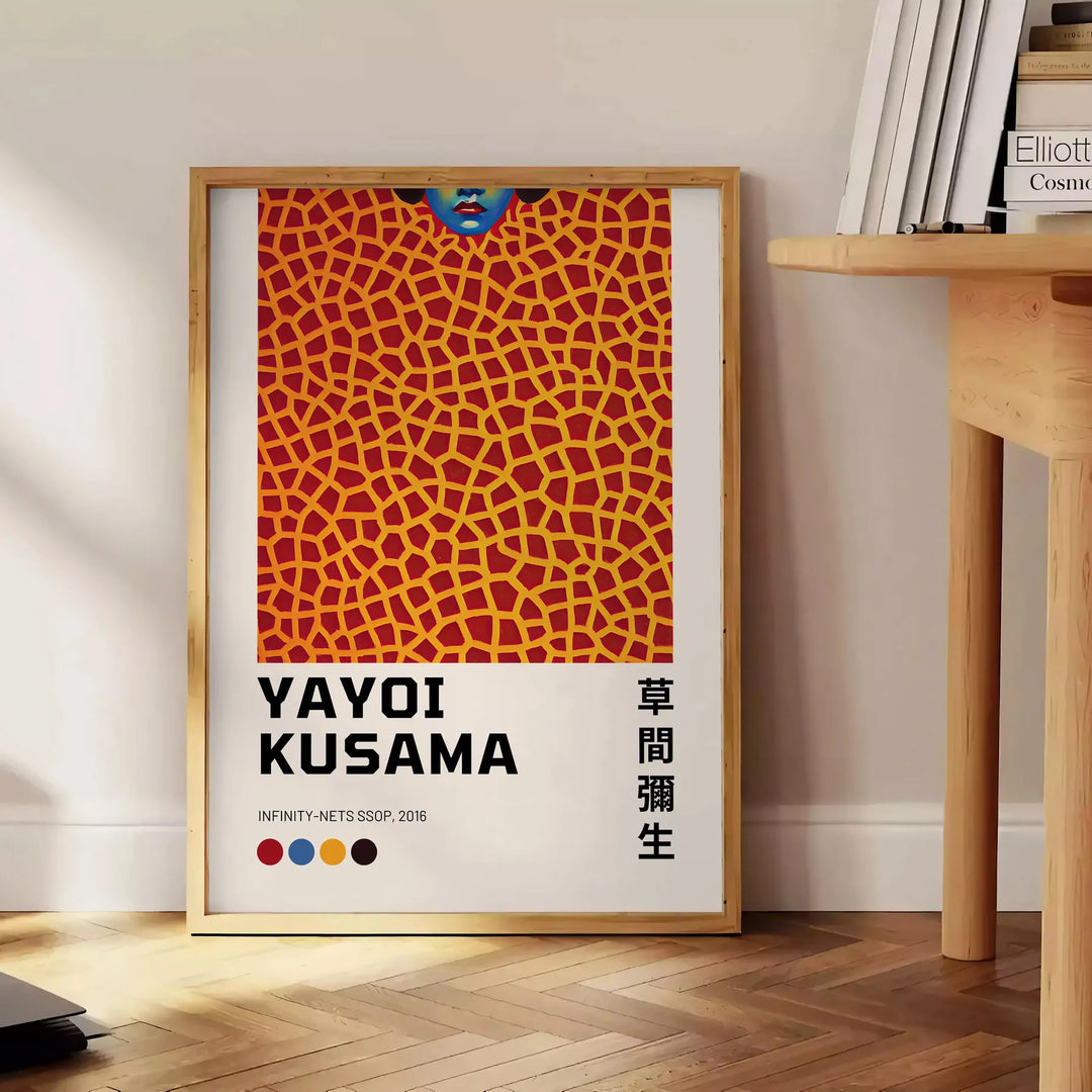 Abstract polka dot patterns in black and orange by Yayoi Kusama - beside a round wooden side table with books