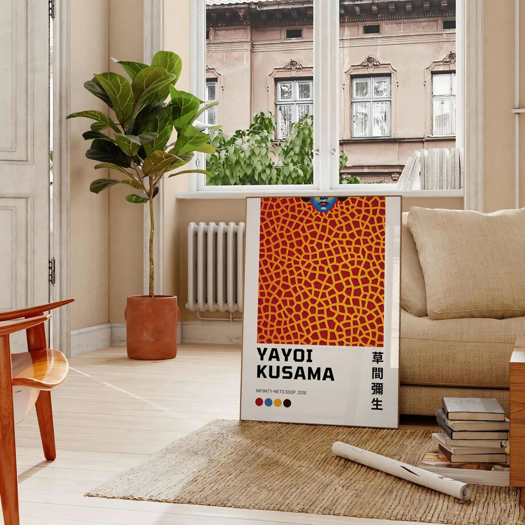 Abstract polka dot patterns in black and orange by Yayoi Kusama - in a Parisian living room with a sofa and a fig plant