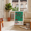 Abstract polka dot patterns in black and blue by Yayoi Kusama - in a Parisian living room with a sofa and a fig plant