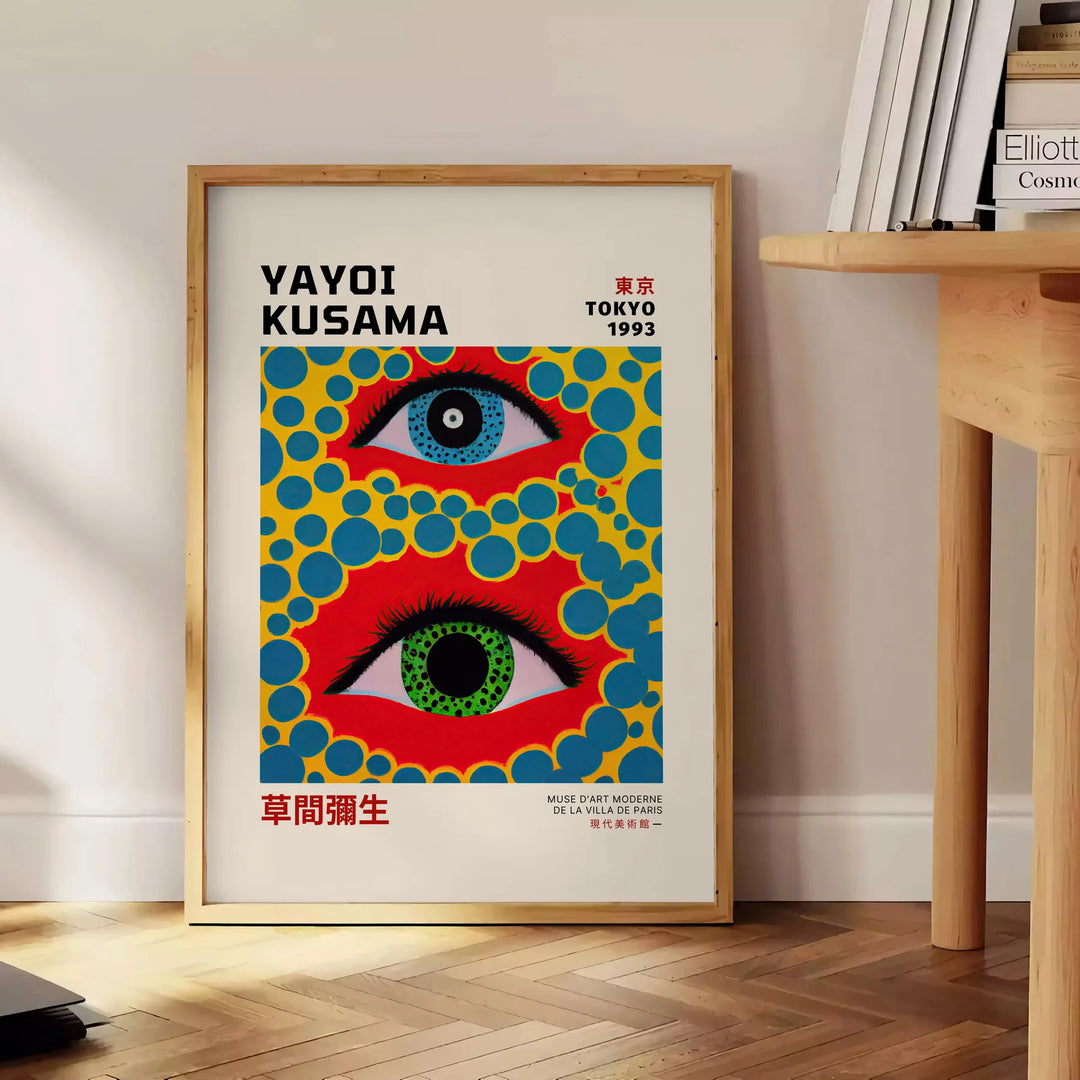 Abstract polka dots in orange and blue by Yayoi Kusama - beside a round wooden side table with books