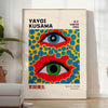 Abstract polka dots in orange and blue by Yayoi Kusama - in a bright minimalist room with a plant and an armchair