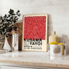 Red dots on a white background with black accents by Yayoi Kusama - styled on a counter with eucalyptus and a bowl of lemons