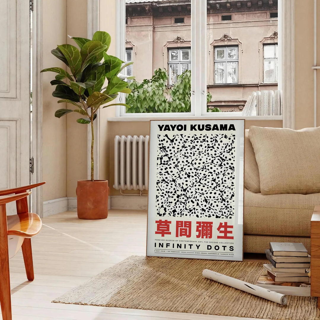 Abstract polka dot patterns in orange and black by Yayoi Kusama - in a Parisian living room with a sofa and a fig plant