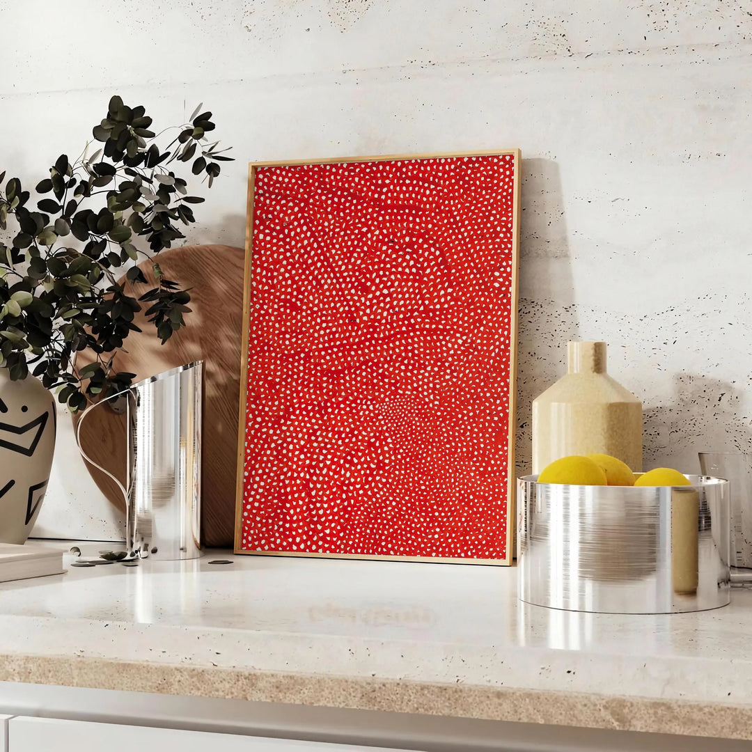 Abstract polka dot patterns in orange and brown by Yayoi Kusama - styled on a counter with eucalyptus and a bowl of lemons