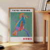 Colorful polka dots in various sizes on a brown background by Yayoi Kusama - beside a round wooden side table with books