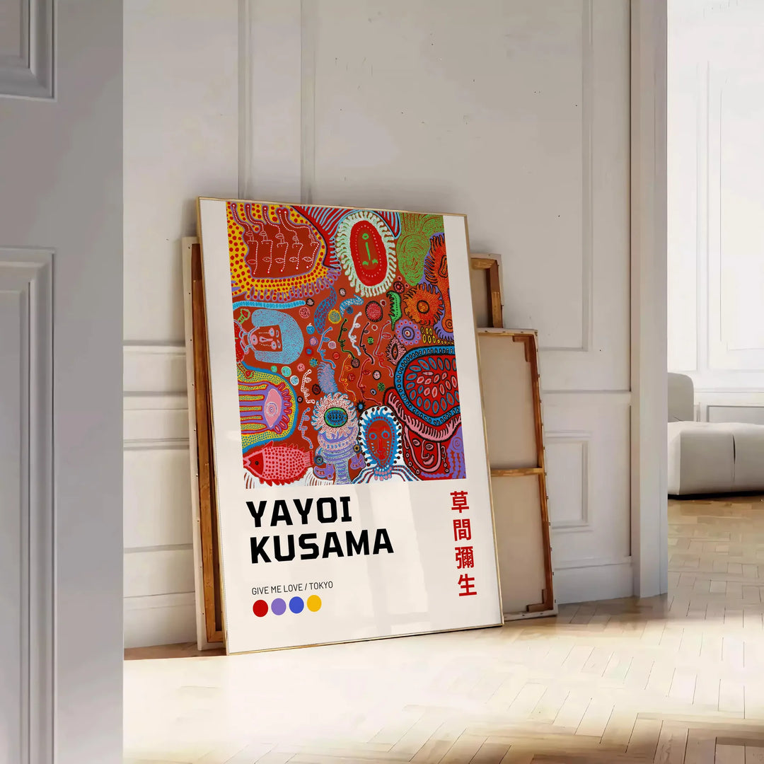 Colorful polka dots in green and orange by Yayoi Kusama - leaning on a herringbone floor against a white panelled wall