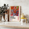 Colorful polka dots in green and orange by Yayoi Kusama - styled on a counter with eucalyptus and a bowl of lemons