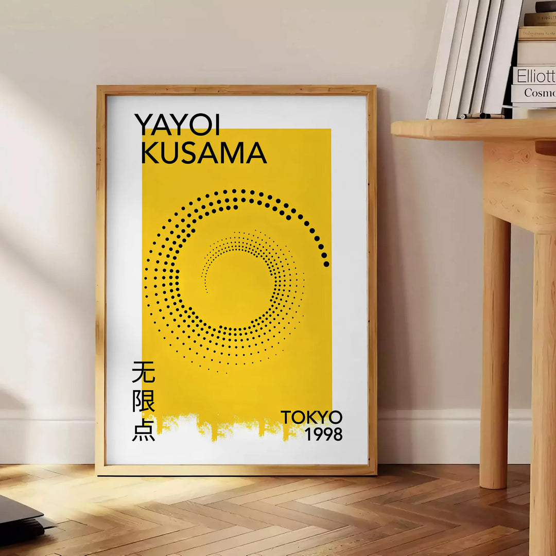 Abstract polka dot design in orange and black by Yayoi Kusama - beside a round wooden side table with books