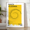 Abstract polka dot design in orange and black by Yayoi Kusama - in a bright minimalist room with a plant and an armchair