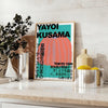 Abstract polka dot pattern in blue and brown by Yayoi Kusama - styled on a counter with eucalyptus and a bowl of lemons