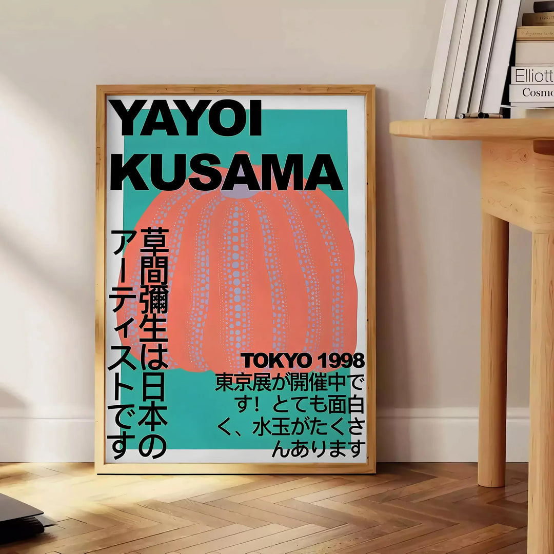 Abstract polka dot pattern in blue and brown by Yayoi Kusama - beside a round wooden side table with books