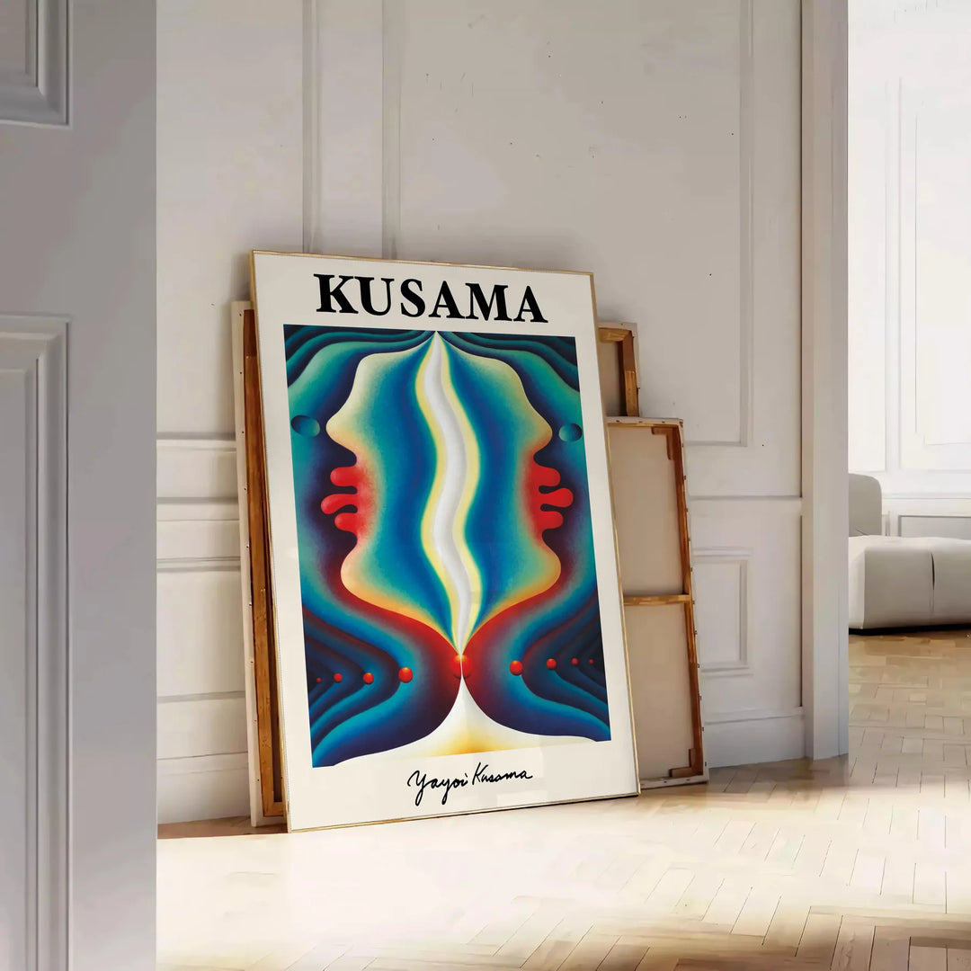 Colorful polka dots in orange and green by Yayoi Kusama - leaning on a herringbone floor against a white panelled wall