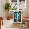 Colorful polka dots in orange and green by Yayoi Kusama - in a Parisian living room with a sofa and a fig plant
