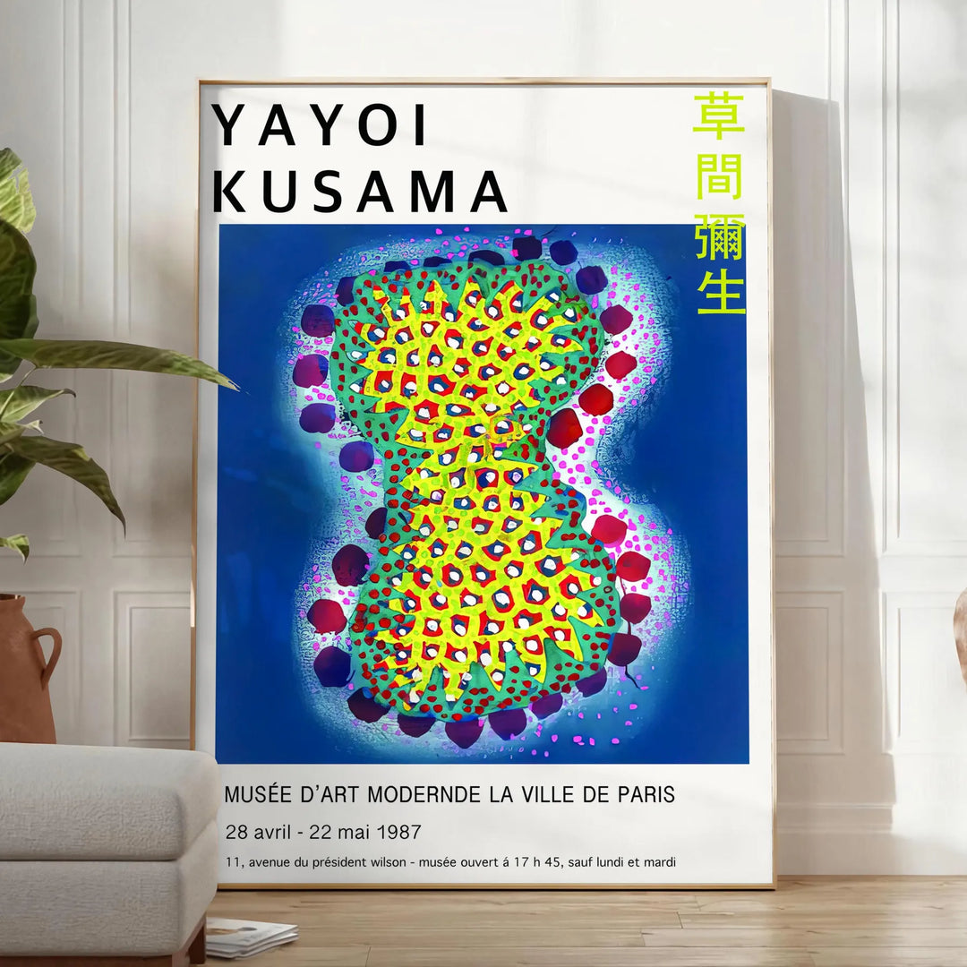 Colorful polka dots in various sizes on a deep blue background by Yayoi Kusama - in a bright minimalist room with a plant and an armchair
